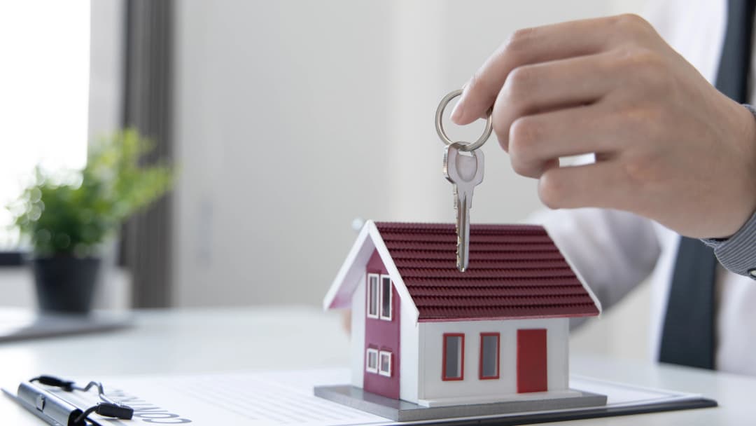 Hand holding house keys